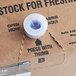 A close up of a Pure Craft Beverages Root Beer Float bag in a box with a blue button.
