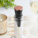 A Franmara copper-plated plastic bottle stopper on a bottle with a cork.