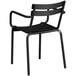 A black Lancaster Table & Seating outdoor arm chair with metal legs.