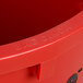 A close up of a red Continental Huskee round trash can with the words "bag cinch" on it.