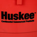 A close up of a red Continental Huskee commercial trash can.