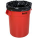 A red Huskee trash can with a black bag inside.
