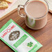A glass of hot chocolate next to a Land O Lakes Cocoa Classics Irish Creme and Chocolate packet.
