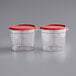 Two clear plastic containers with red lids.