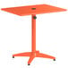 An orange rectangular Lancaster Table & Seating dining height outdoor table with a black top.