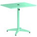A seafoam green Lancaster Table & Seating dining table with a black circle on top.
