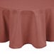 A mauve Intedge round tablecloth on a table.