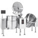 A group of stainless steel Cleveland twin steam jacketed mixer kettles.