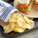 A sandwich and Good's Blue Original Kettle Cooked Potato Chips on a tray.