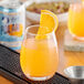 A glass of Polar Diet orange juice with a slice of orange on top.