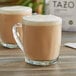 A glass mug filled with Tazo London Fog Latte concentrate with foam on top.