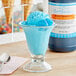 A glass with blue ice cream flavored with LorAnn Blue Raspberry syrup.