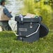 A man fishing with a CaterGator Charcoal outdoor cooler in the grass.