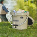 A man fishing in a CaterGator tan cooler.