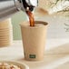 A New Roots smooth kraft paper hot cup being filled with coffee