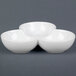 A white three-tiered bowl with three bowls.