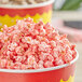 A bowl of popcorn with red and white Great Western Cherry Popcorn Glaze.