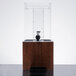 A clear beverage dispenser with a dark wood base and lid.