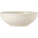 A close up of a Libbey Porcelana cream white porcelain pasta bowl with a rolled edge.