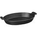 A black oval Chasseur enameled cast iron casserole dish with handles.