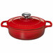 A Chasseur ruby red enameled cast iron casserole dish with a lid and handle.