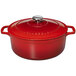 A ruby red Chasseur enameled cast iron dutch oven with a lid.