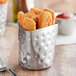A Tablecraft stainless steel fry cup with chicken nuggets in it.