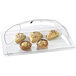 A Cal-Mil clear plastic dome cover with double ends over a tray of food.