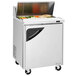A Turbo Air stainless steel refrigerated sandwich prep table with a door.