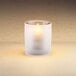 A Sterno Frost Mini Bubbles liquid candle holder with a lit candle inside.
