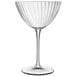 A clear Luigi Bormioli martini glass with a curved stem.