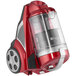 A red Atrix bagless canister vacuum with a clear lid.