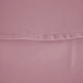 A close-up of a pink fabric table cover with a hemmed edge.