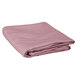 An Intedge round pink hemmed cloth table cover folded on a white background.