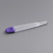 A white rectangular plastic storage case with a clear plastic tube inside with a purple cap.