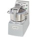 A Robot Coupe stainless steel food processor with a lid.