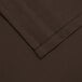 A close up of a brown cloth with a folded edge.