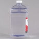 A clear plastic bottle with a red lid and label of Sterno Soft Light Liquid Candle Paraffin Wax.