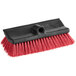 A close-up of a red and black Lavex floor scrub brush.