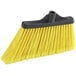 A yellow Lavex angled broom head with black flagged bristles.