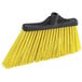 A yellow Lavex broom head with black bristles.