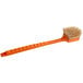 A Fryclone utility brush with an orange handle.