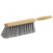 A close up of a Lavex counter brush with grey bristles.