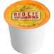 A white container of Ellis Red Eye coffee single serve cups with an orange lid on a table.