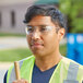 A man wearing Honeywell Uvex safety glasses and a reflective vest.