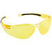 A pair of yellow safety glasses with black frames and straps.