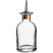 An Arcoroc clear glass bitters bottle with a dasher spout.