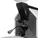 A Primo GENESIS-Xr3 coffee roaster with a metal handle.