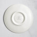A white RAK Porcelain flat plate with an embossed circle design on the rim.