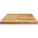An Elite Global Solutions faux wood rectangular riser on a wooden surface.